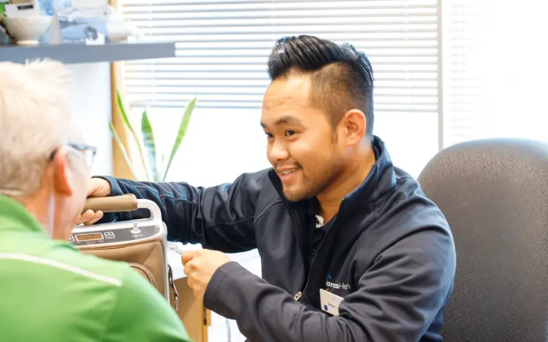 A Careica Health Oxygen Clinician demonstrates how to use a portable oxygen concentrator